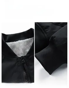 Detail view of winter bomber jacket showing fleece collar, metal zipper, and ribbed cuffs