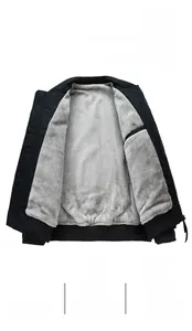 Detail view of men's jacket showing soft grey fleece lining and premium zipper