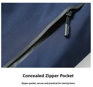Detail of hidden zipper pocket on navy blue outdoor jacket with decorative fashion puller