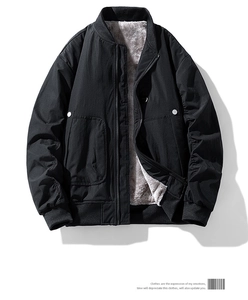 Detail view of black winter jacket showing gray fleece lining and ribbed windproof cuffs