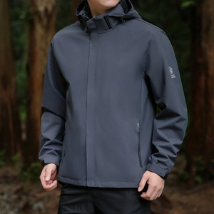 Men's dark grey hooded outdoor windbreaker jacket with technical fabric in forest setting