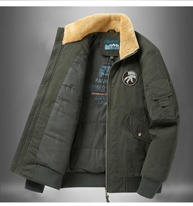 Detail view of military green winter jacket featuring warm yellow fleece lining and rib cuffs