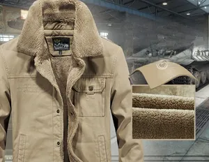 Close-up of khaki winter jacket featuring warm brown faux shearling lining and embroidery
