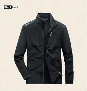Close-up of black fleece vest with orange zipper details and functional chest pocket