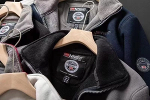Detail of fleece jacket collar with woven brand label and high-density thermal fabric
