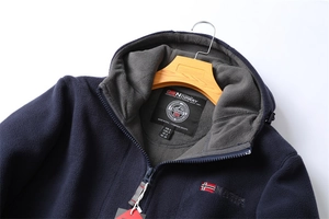 Detail of the warm double-layer fleece lining and Norway flag embroidery on the navy jacket