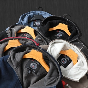 Stacked variety of thick polar fleece hoodies showing multiple colors and Norway neck labels