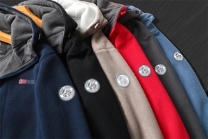 Macro detail of six color fleece hoodies featuring Norway Outdoor embroidery on sleeves