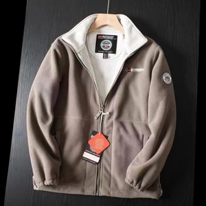 Close-up of khaki fleece jacket with brand logo embroidery and contrast collar detail