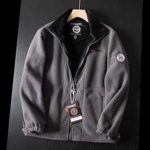 Detail of warm black faux fur lining and red Norway flag embroidery on fleece jacket