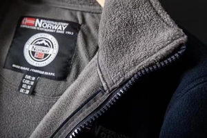 Macro detail of thermal fleece jacket interior with premium zipper and neck label
