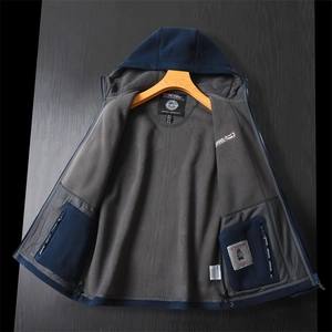 Detail of hooded jacket interior with grey fleece lining, mesh pocket and branded labels