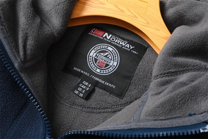Close-up of Norway logo outdoor jacket with thick double-layer gray fleece lining detail
