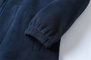 Detail of navy blue fleece jacket featuring elastic ribbed cuffs and heavy thermal texture