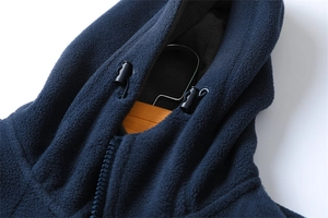 Macro shot of navy fleece hoodie neckline with zipper and black adjustable drawstring