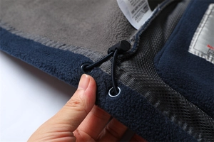 Detail of outdoor fleece jacket with adjustable elastic drawstring and mesh pocket