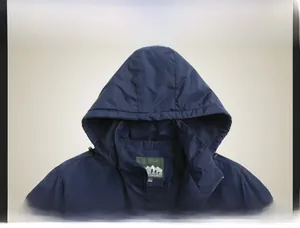 Detail view of navy blue winter jacket featuring a detachable hood and windproof fabric