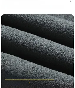 Macro detail of 100% polyester dark grey polar fleece fabric showing soft warm texture