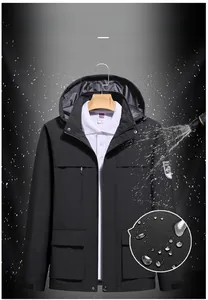 Detailed close-up showing water-repellent fabric on black outdoor hooded jacket