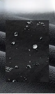 Macro shot of water-repellent outdoor fabric with droplets on dark grey surface