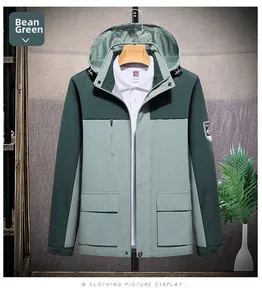 Macro shot of waterproof pea green hooded jacket with tactical pockets and Velcro cuffs