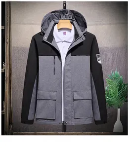 Detail of waterproof outdoor jacket showing hooded collar and contrasting chest zipper pocket