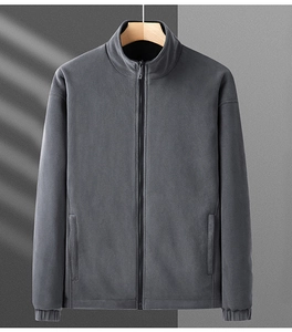 Detail view of dark grey reversible fleece jacket featuring elastic cuffs and zipper