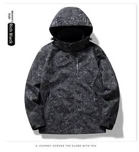 Detail view of women's rich black windbreaker featuring subtle tropical leaf patterns