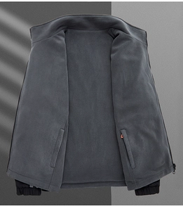 Detailed view of dark gray fleece jacket interior with large pockets and elastic cuffs