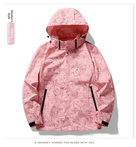 Detail of adjustable black velcro straps on cuffs of a pink camo waterproof outdoor jacket