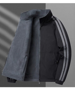 Detail view of men's reversible jacket showing warm gray fleece lining and sleeve stripes