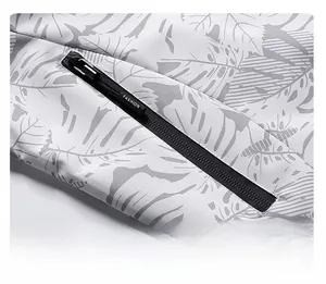 Detail of waterproof camouflage jacket with secure zipper pocket and palm leaf texture