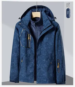 Close-up of leaf pattern camo and waterproof zipper pockets on blue outdoor jacket