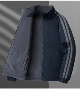 Detail view of navy fleece-lined jacket featuring windproof fabric and sleeve stripes