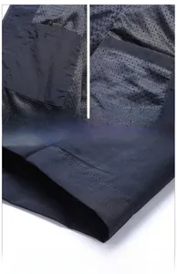 Detail of navy blue vest showing large capacity inner pockets and mesh lining craft
