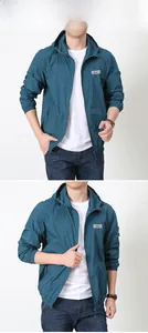 Detail view of peacock blue outdoor hooded jacket with functional arm zipper pocket