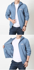 Detail of the blue lightweight outdoor hooded jacket with chest print and zipper pocket