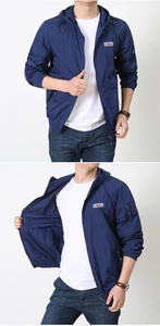 Detail of outdoor sun protection jacket featuring arm zipper pocket and chest printed logo