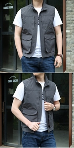 Detailed view of dark grey outdoor fishing vest featuring multi-pocket utility design