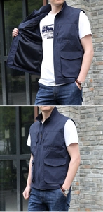 Detail of navy outdoor vest showing durable zipper closure and functional cargo pockets