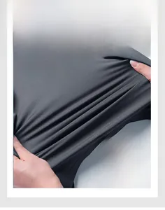 Close-up of high elasticity dark grey fabric being stretched to show super rebound