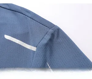 Close-up of shoulder seam on blue-grey ice silk t-shirt showing breathable mesh texture