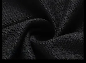 Vue macro du tissu respirant texturé sur le col d'un polo noir pour homme