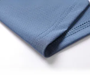 Detail of blue ice silk t-shirt featuring breathable mesh fabric and double-stitched hem