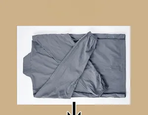 Detailed view of the packable grey sun protection jacket folded for easy travel and storage