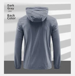 Detail view of the back of a dark gray hooded sun protection jacket with elastic cuffs
