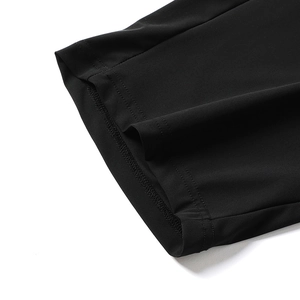 Detailed close-up of double-stitched hem on men's black quick-dry lightweight ice silk pants
