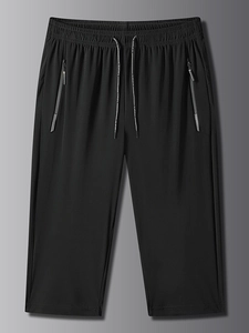 Detail of men's quick-dry sport pants featuring elastic waist and KE SPORTS drawstrings