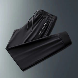 Detailed macro view of elastic drawstring waistband and zip pocket on men's track pants