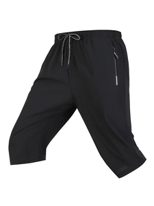 Detail of men's quick-dry black sports pants showing elastic waistband and drawstring
